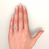 Heart shape aquamarine and diamonds halo ring in white gold on hand