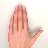 Heart shape aquamarine and diamonds halo ring in white gold on hand